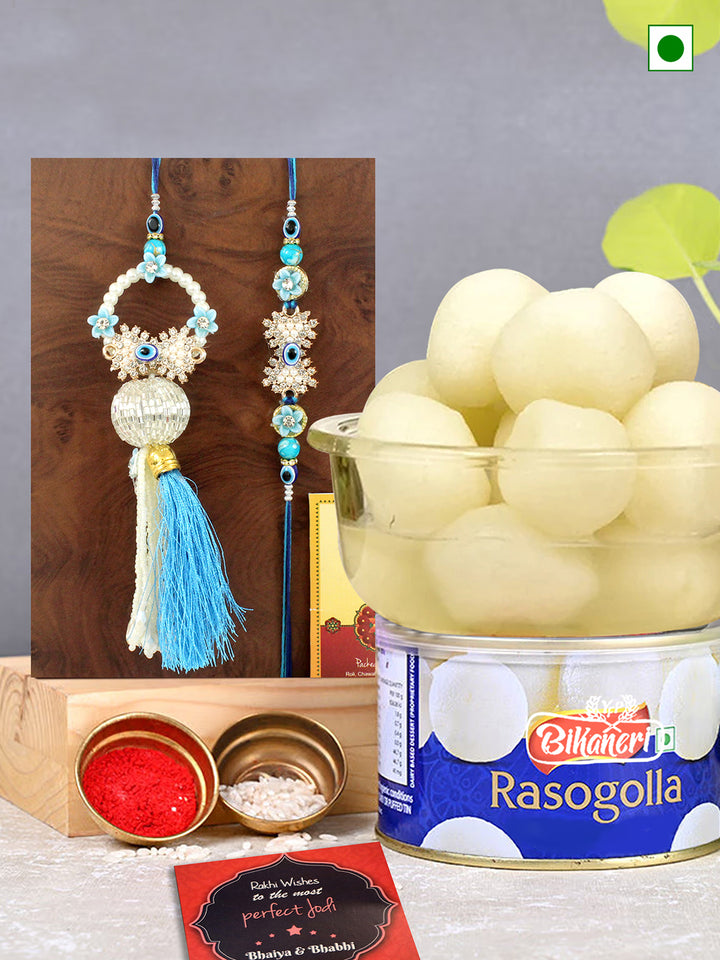 Designer Lumba Rakhi Set of 2 for Bhaiya-Bhabhi with Sweets (Rasgulla), Card and Tikka